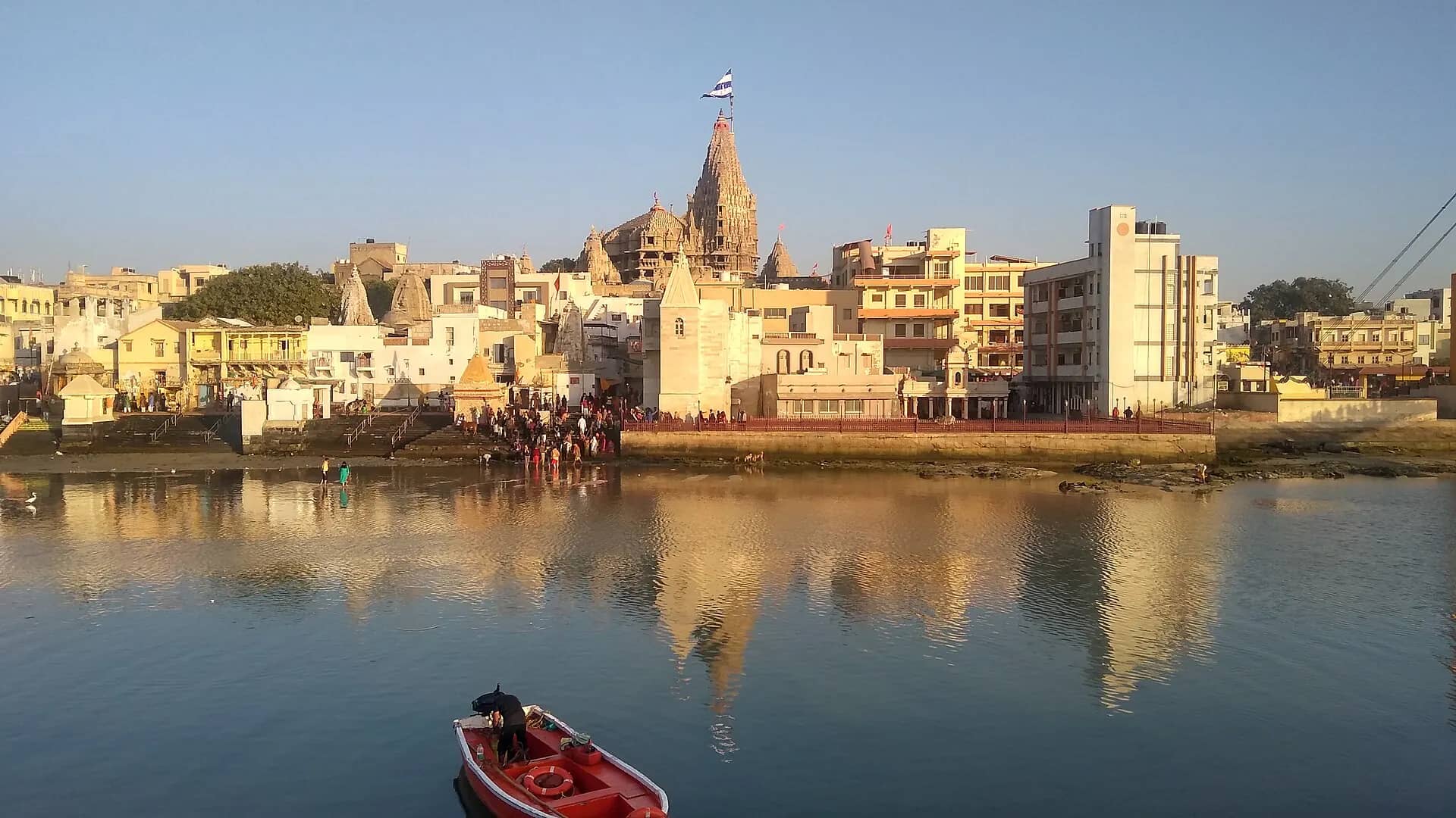 Dwarkadhish temple reflected in the Gomti river, Dwarka